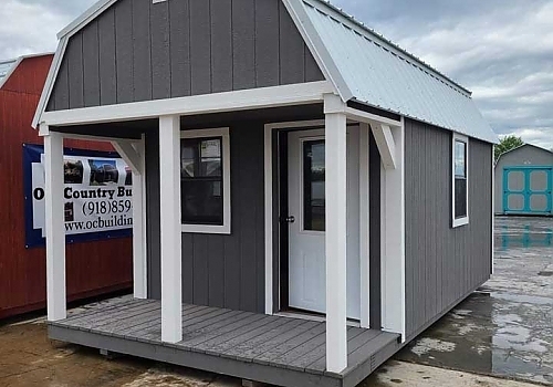 Gray cabin with white trim and open porch | Summit, OK